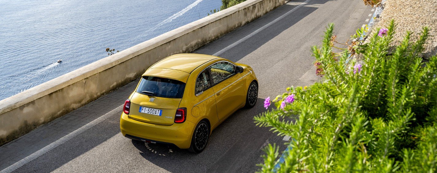 Yellow 500 Hybrid driving on a coastal road, seen from above.