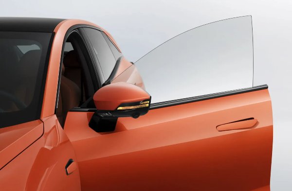 Orange car with the driver's door open and side mirror indicator visible.
