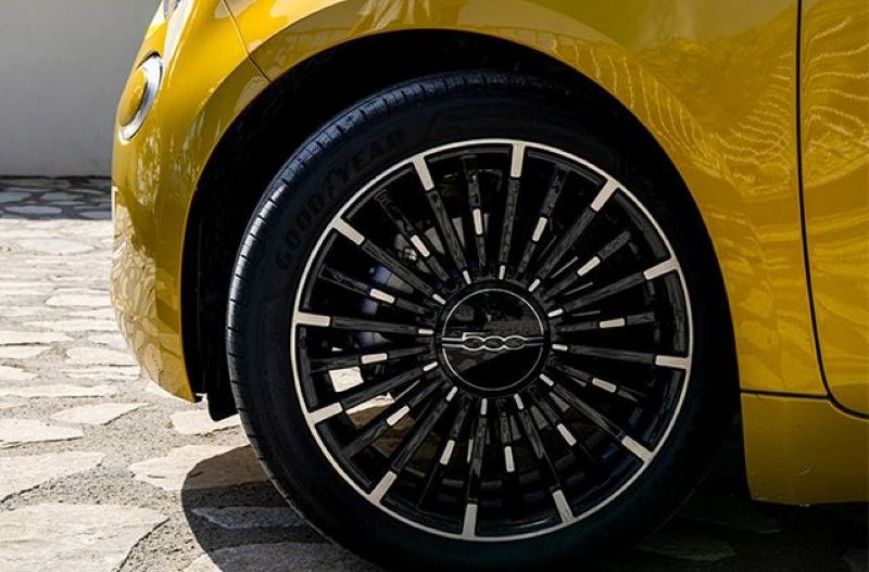 Close-up of a yellow 500 Hybrid front wheel with black alloy design.