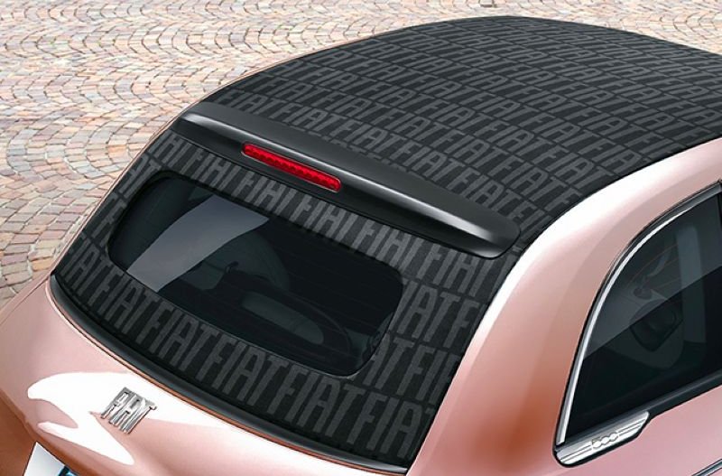 Convertible roof with fiat branding over it placed on a pink Fiat 500 Hybrid