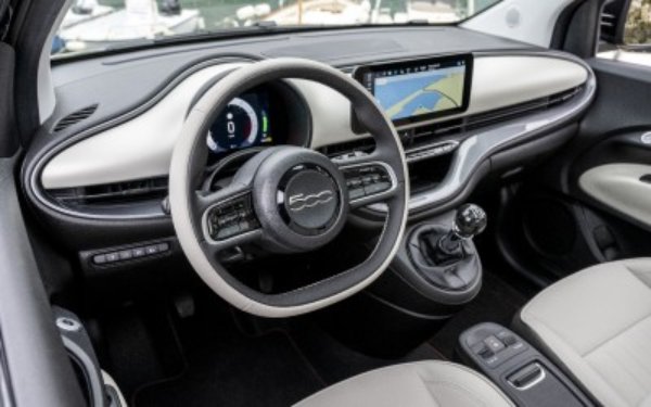 Interior of the New 500 Hybrid showing steering wheel, dashboard, and digital display.
