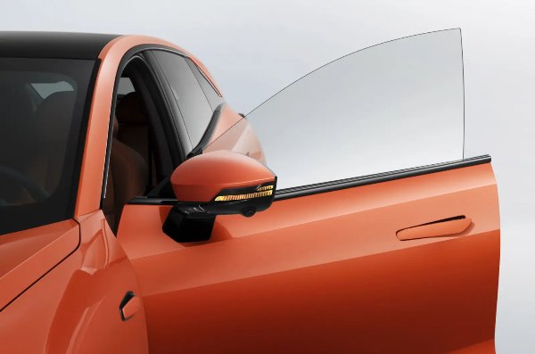 Orange car with door open and side mirror visible.