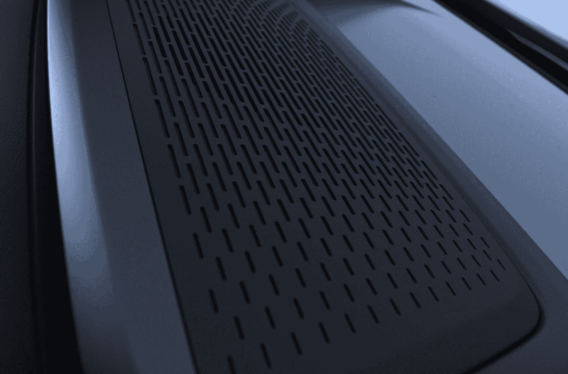 Close-up of a perforated surface on a dark-coloured device.