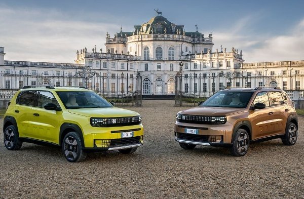 Two modern SUVs parked in front of a grand historic building.